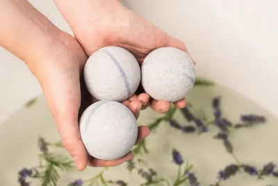 Three organic and American made bath bombs wait to be used in a tub. 