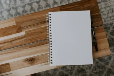 A blank notepad on a table.