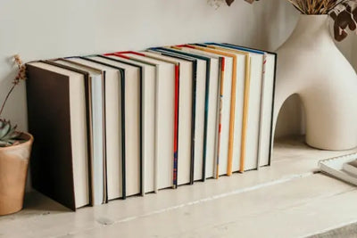 Multiple colored books on a shelf.