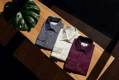 Three folded button down shirts.