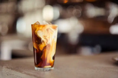 An iced coffee is mixed with an American-made vanilla syrup. 