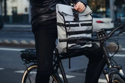 A bag connected to a black bicycle. 