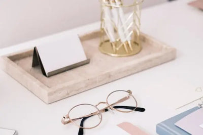 Card and pen holder on a desk.