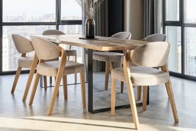 A modern dining room with a wooden table, six upholstered chairs, and a vase centerpiece. Floor-to-ceiling windows reveal a city skyline, while dark curtains and natural light enhance the cozy space.