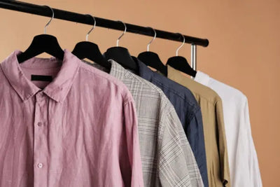 Five dress shirts on hangers. 