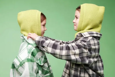 Two girls wearing green, American-made hoodies.