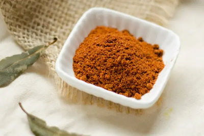 A small dish holding paprika.