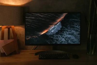 A modern, industrious lamp on a computer desk.