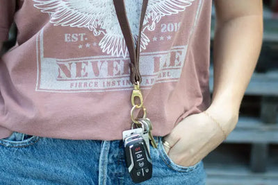 A woman wearing a leather lanyard around her neck.