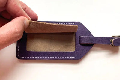 A blue leather luggage tag with American made leather, sewn in Maine.