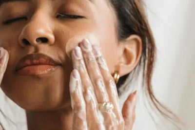 A woman washing off her makeup.