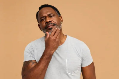 An American man wearing grey pajamas that were manufactured in the United States of America. 