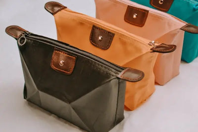 Three pouches, with colors ranging from black to green, made with American made leather. 