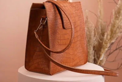 Brown leather purse strap and purse.