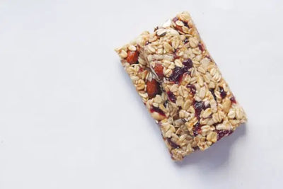 Two granola bars sitting on a white table.