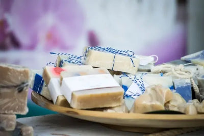  A wooden table of organic, handcrafted soaps sit at an American craft show. 