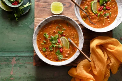 Two white bowls with soup.