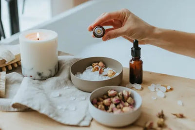 A candle, bath salts and serums for self care.