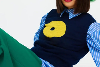 A blue vest with yellow designs was made in America.