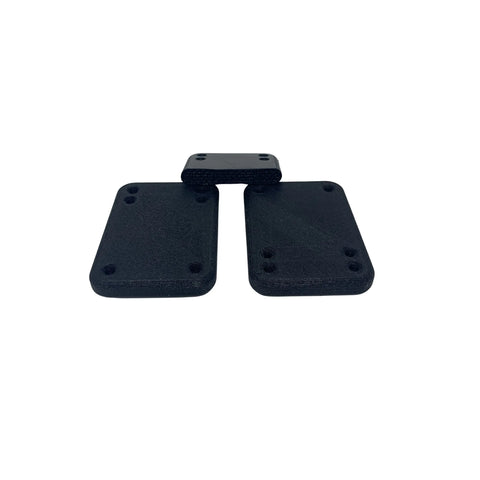 Three Chatelet Manufacturing Longboard/Skateboard 1/4 Inch Premium Riser Shock Pads are arranged on a white background, with two larger pads side by side and a smaller one above, partially overlapping. These pads offer enhanced shock absorption for smoother rides.