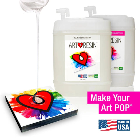 Crystal-clear 10 Gallon (37.8 L) ArtResin epoxy resin from ArtResin is poured over vibrant heart artwork. Two large containers, Make Your Art POP®, and a Made in USA label highlight this perfect resin for stunning art creations.