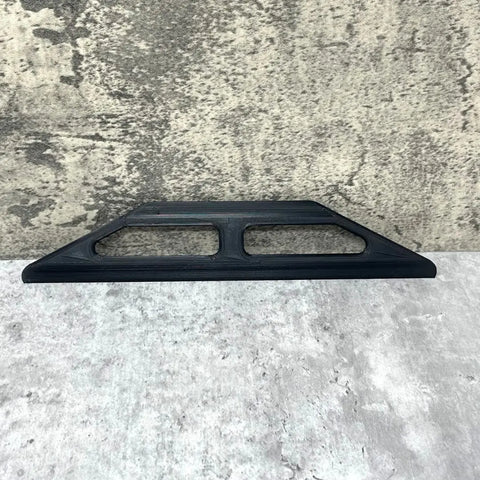 The Chatelet Manufacturing 10-Inch Plastic Paint Guide and Trim Guard, featuring two rectangular cutouts and a rigid black triangular design, rests on a grey textured surface—perfect for precision painting on DIY or professional jobs.