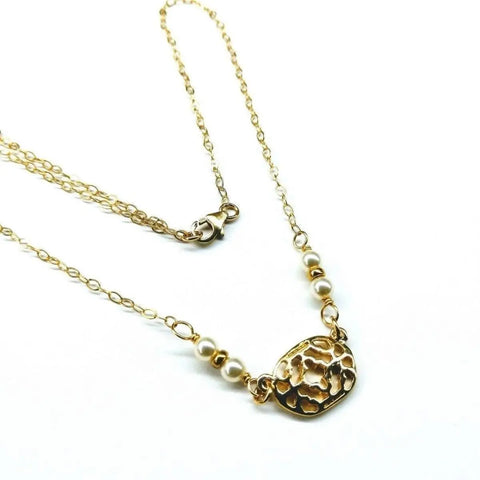 The As Seen on Molly Ringwald 14K Gold Filled Filigree Pearl Choker Necklace by Alexa Martha Designs features a textured gold oval pendant and Swarovski crystal pearls, shown against a white background.
