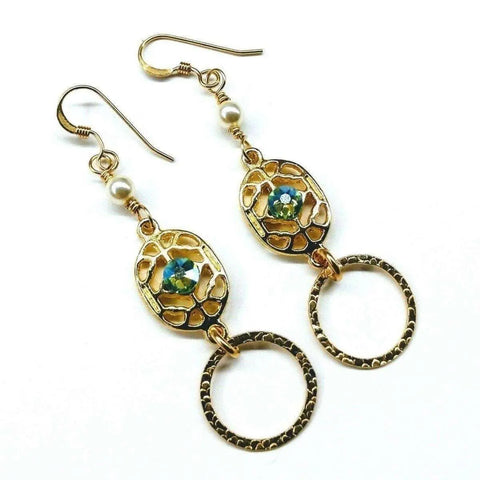 Alexa Martha Designs 14 KT Gold Filled Green Crystal Hammered Circle Filigree Earrings feature intricate oval designs, green crystals at the center, small white beads by the hooks, and textured open circle charms below.