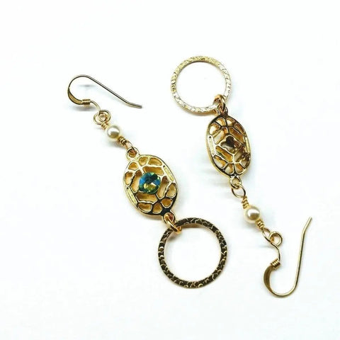Alexa Martha Designs 14 KT Gold Filled Green Crystal Hammered Circle Filigree Earrings feature asymmetrical dangles with textured circles, a green crystal center, and small white beads on gold wire hooks.