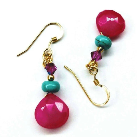 The 14 KT Gold Filled Wire Wrapped Pink and Turquoise Drop Gemstone Earrings by Alexa Martha Designs feature hot pink chalcedony teardrops, turquoise rounds, and purple crystals for a vibrant, eye-catching look.