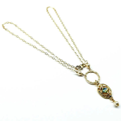 The 14K Gold-Filled Hammered Open Circle Filigree Necklace by Alexa Martha Designs features a decorative pendant with colorful enamel and Swarovski crystal pearls, handmade in Montana and displayed on a white background.