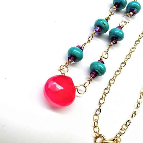 The Alexa Martha Designs Gold Filled Pink Chalcedony Turquoise Gemstone Drop Necklace features turquoise and purple beads with a bright pink teardrop pendant, beautifully displayed on a white surface.