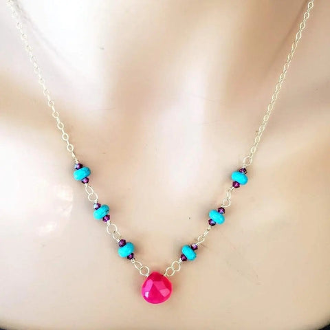 The Alexa Martha Designs Gold Filled Pink Chalcedony Turquoise Gemstone Drop Necklace features alternating turquoise and purple beads with a teardrop pink pendant, displayed on a mannequin bust.