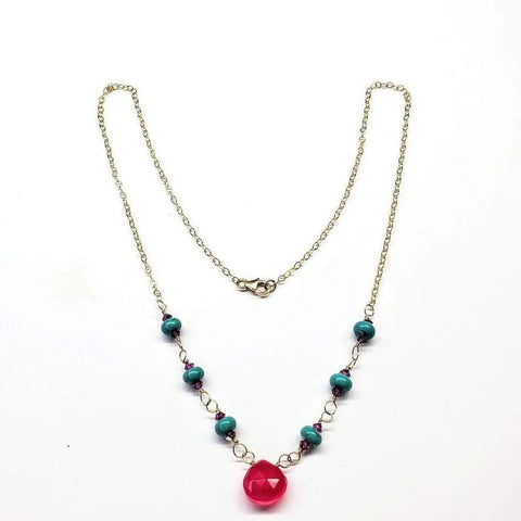 Alexa Martha Designs Gold Filled Pink Chalcedony Turquoise Gemstone Drop Necklace features turquoise beads and a large faceted pink chalcedony centerpiece, shown on a white background.
