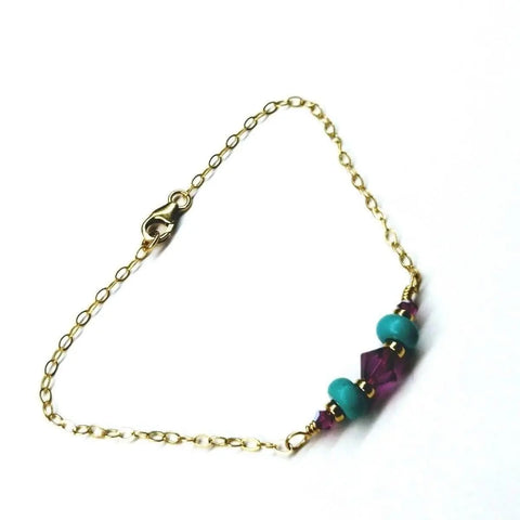 The Gold Filled Pink Turquoise Gemstone Bracelet by Alexa Martha Designs features pink and turquoise beads centered on a delicate 14k gold filled chain with a lobster clasp—a stunning handcrafted jewelry piece.