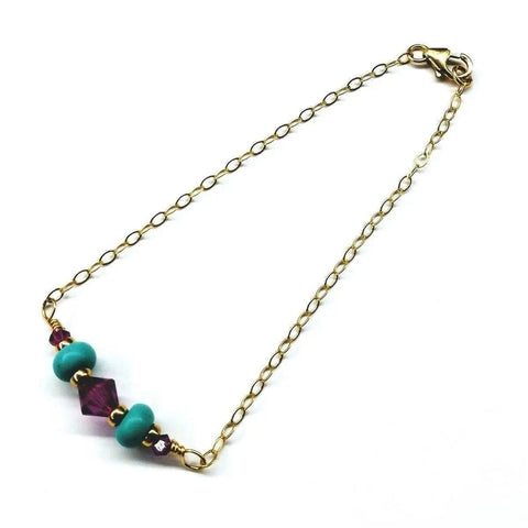 The Gold Filled Pink Turquoise Gemstone Bracelet by Alexa Martha Designs features pink and turquoise beads at the center and a lobster clasp, making it an ideal handcrafted jewelry piece.