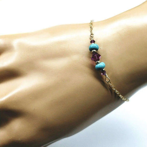 The Alexa Martha Designs Gold Filled Pink Turquoise Gemstone Bracelet is displayed on a mannequin hand, highlighting the elegance of handcrafted jewelry against a white background.