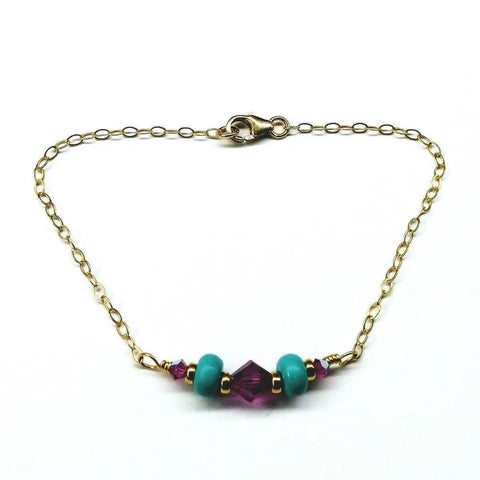 The Gold Filled Pink Turquoise Gemstone Bracelet by Alexa Martha Designs features pink turquoise and purple beads with a secure lobster clasp—a stunning handcrafted accessory.