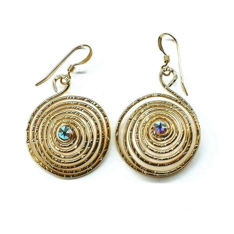 The Gold Filled 14CT Crystal Spiral Earrings by Alexa Martha Designs feature round iridescent gems at the center of spiral gold earrings, crafted from 14 kt gold filled wire and displayed on a white background.
