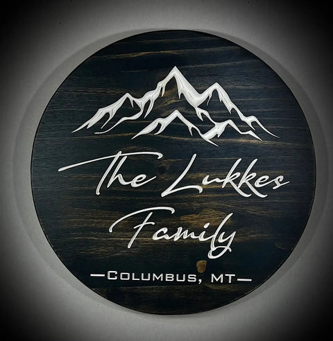 The B. James Design & Woodwork 15 Round Custom Family or Name Sign features an engraved mountain design and personalized text—ideal for unique home décor.