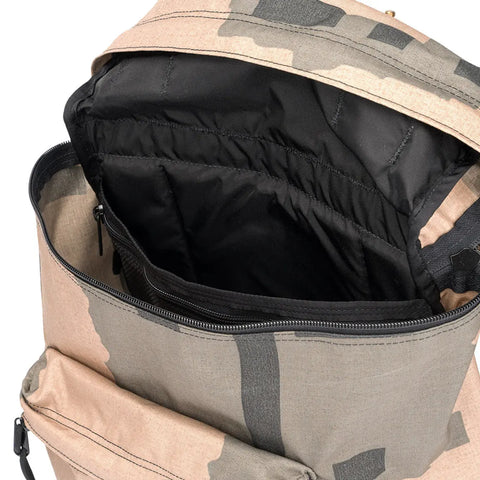 A close-up of the MIS Backpack - T Pattern shows a durable camouflage design, spacious black-lined main compartment with laptop holder, and a partially visible front zippered pocket.