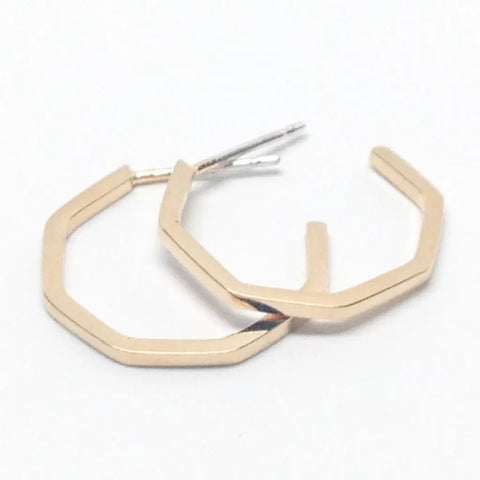 The GOLD GEO HOOPS | SMALL by Sarah Cecelia are minimalist gold earrings with thin, hexagonal shapes and straight edges, shown slightly overlapping on a white background.