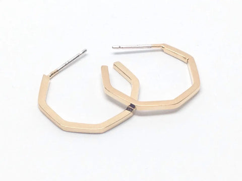 The Sarah Cecelia GOLD GEO HOOPS | SMALL are minimalist 18k gold-plated earrings with straight hexagonal edges and silver posts, creating a striking contrast. They’re pictured flat on a white background.