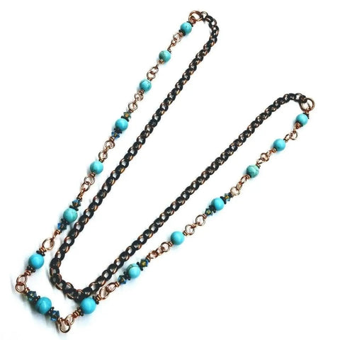 The Wire Wrapped 24 Inches Copper Turquoise Necklace by Alexa Martha Designs features alternating copper and black chain links with round turquoise beads, elegantly displayed on a white background.