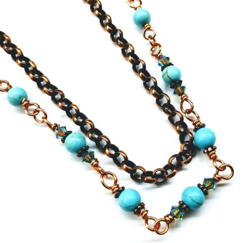 The Wire Wrapped 24 Inches Copper Turquoise Necklace by Alexa Martha Designs combines copper links, Chinese turquoise beads, and blue-green crystals for a colorful, elegant accessory.