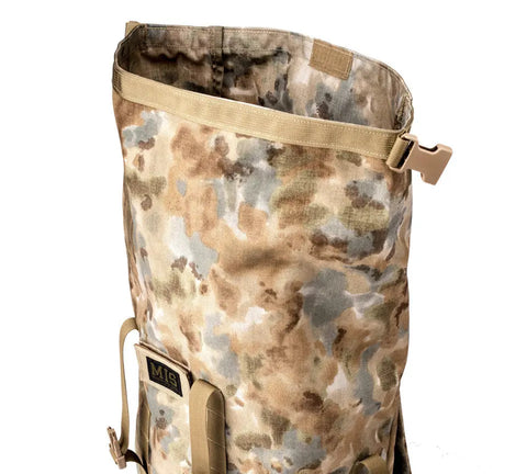 The MIS Roll Up Backpack - Covert Desert features a camouflage Cordura nylon design, tan straps, an open top, side plastic buckle, and front MIS patch. Made in the USA, its built for durability and everyday use.