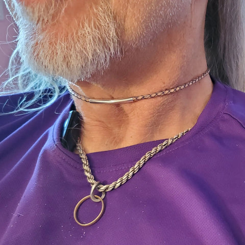A person with a gray beard and long hair styles their look with unique metallic accents, including a purple shirt and the 3mm Bolo Leather Snap Off Choker by Alexa Martha Designs.