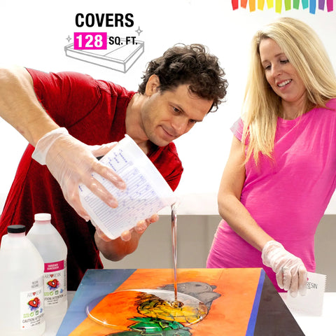 Two people wearing gloves pour 4 Gal (15.14 L) ArtResin epoxy resin onto a colorful painting for a crystal-clear finish. Bottles labeled “ArtResin” are nearby. Above, text reads COVERS 128 SQ. FT., with vibrant art supplies in the background.