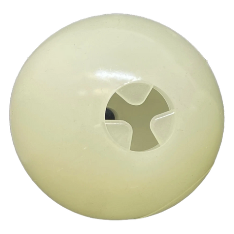 A close-up of the 4 PUP-X EDispenser Glow Ball Treat Dispenser by SodaPup, a round, off-white plastic dispenser with a cross-shaped opening in the center and a smooth, slightly shiny glow-in-the-dark surface.