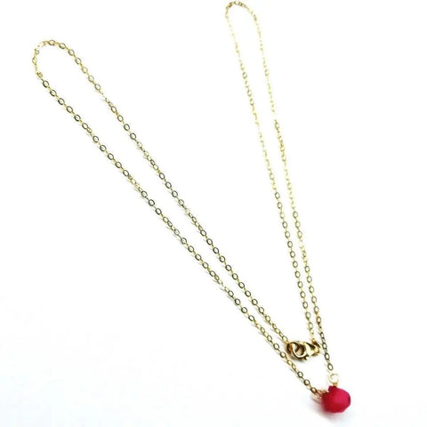 The Tiny Hot Pink Chalcedony Gold Filled Necklace by Alexa Martha Designs features a delicate round hot pink chalcedony bead pendant on a gold-filled chain, displayed against a white background.